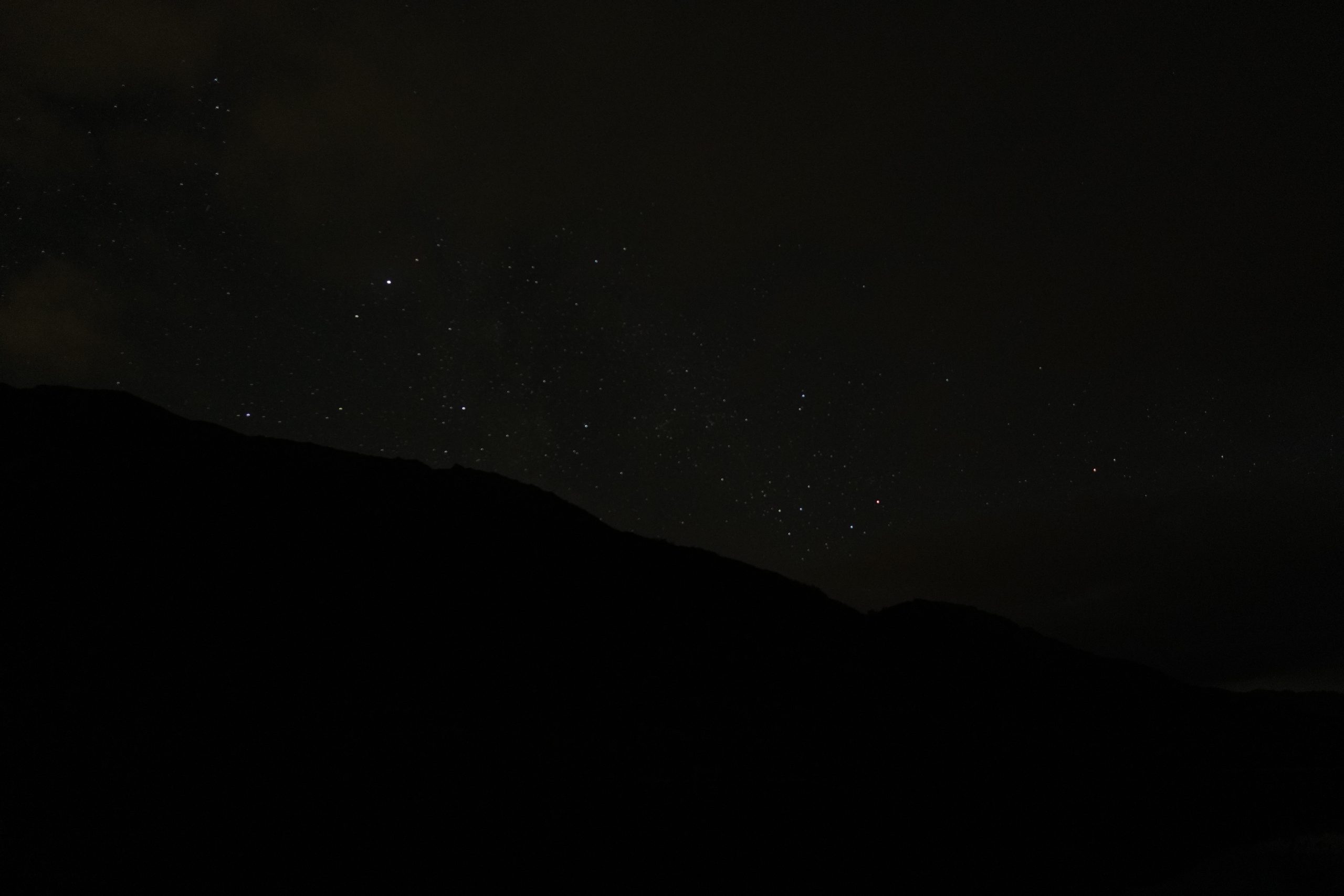 Stars above a dark Lofoten mountain ridge