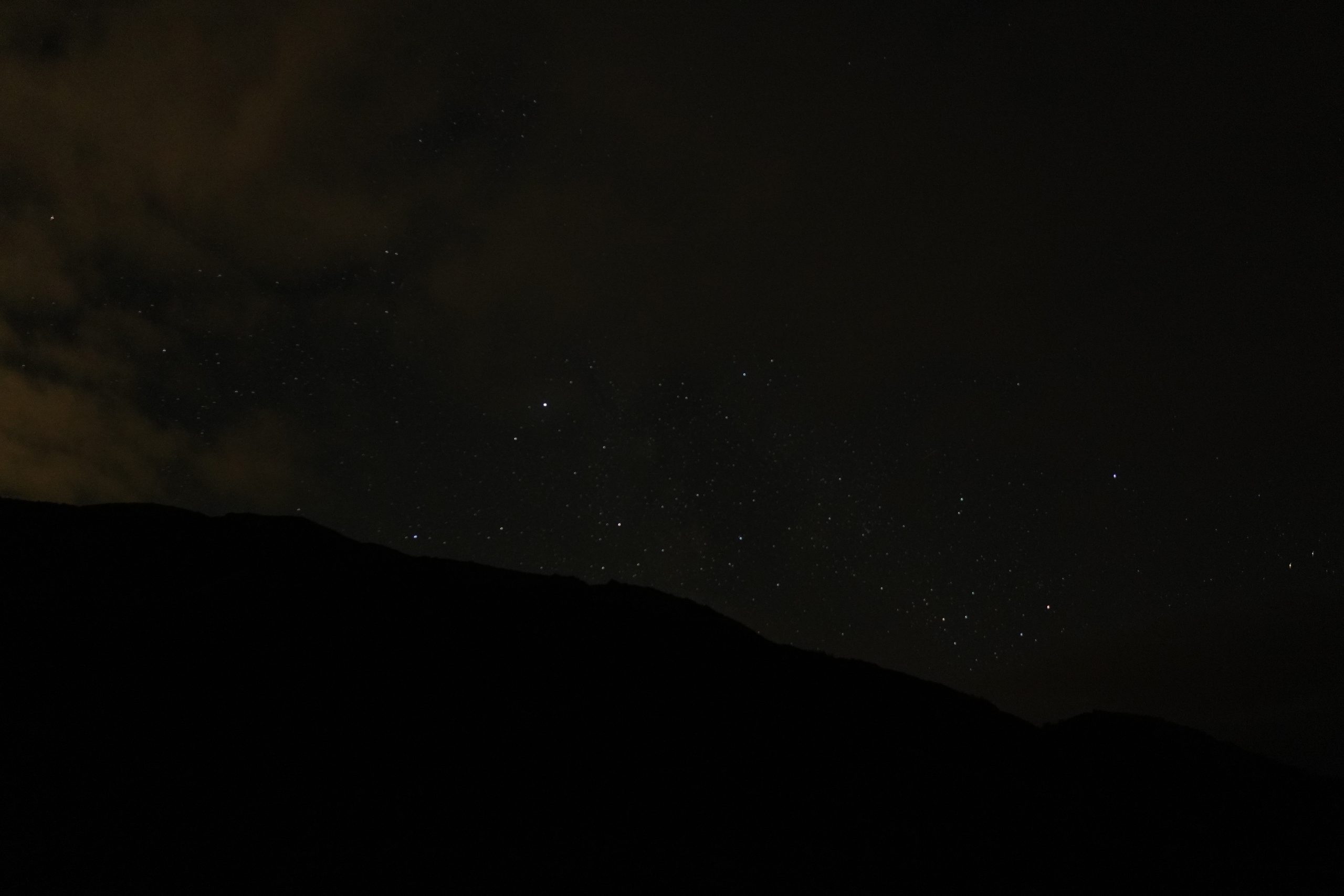 Stars and clouds over a Lofoten silhouette