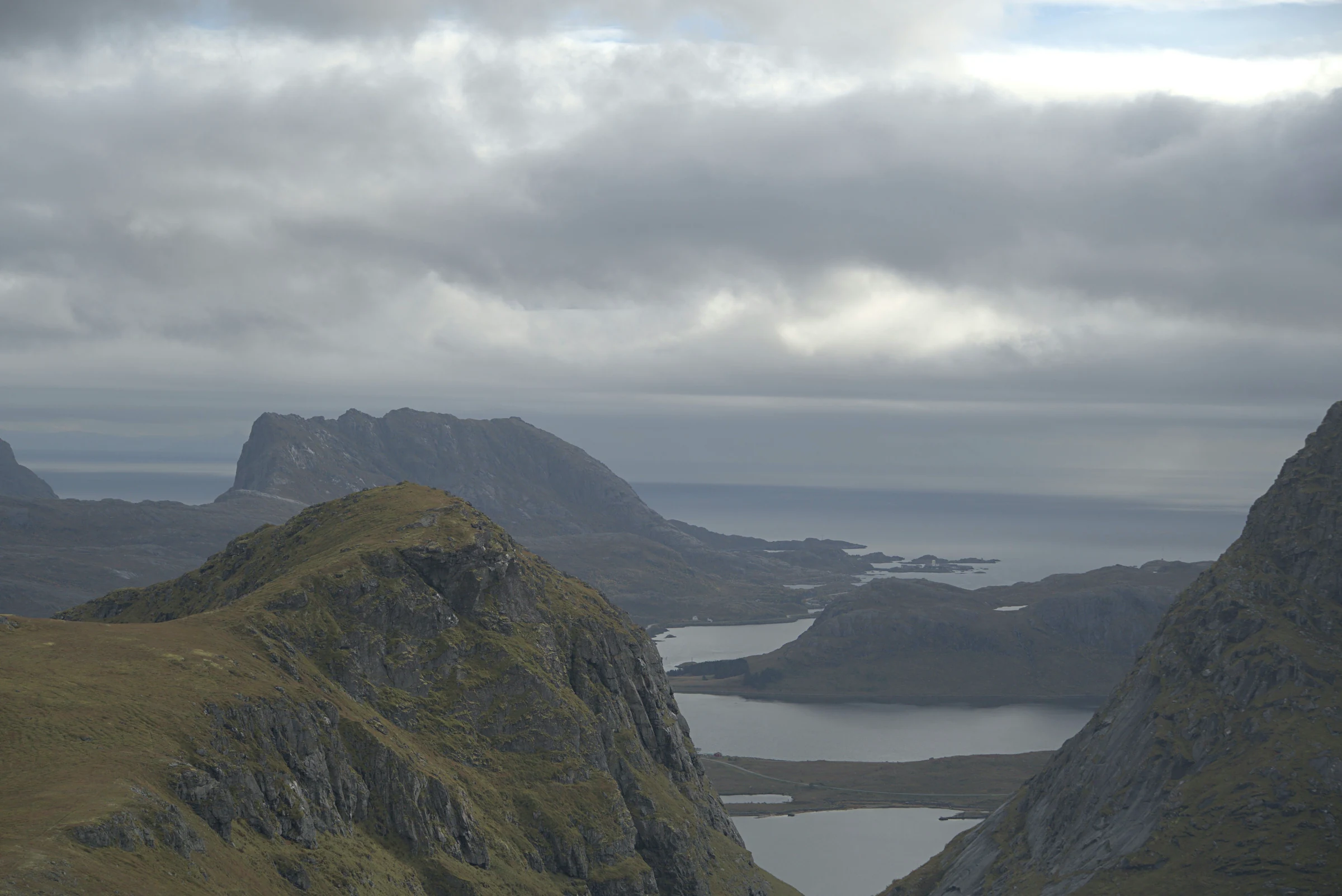 Mountain ridges and fjords beneath an overcast Lofoten sky